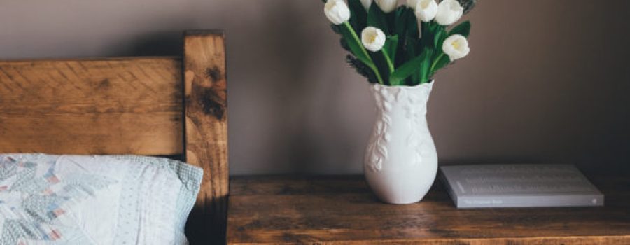 bedside table with vase staging